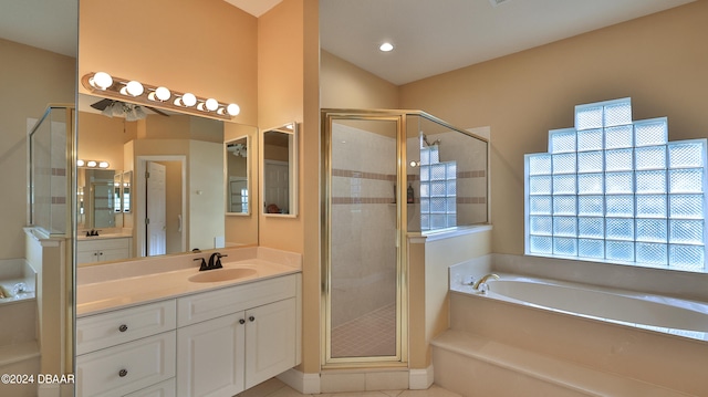 bathroom featuring vanity, tile patterned flooring, and plus walk in shower