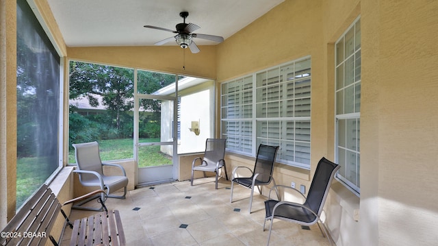 sunroom featuring ceiling fan and lofted ceiling