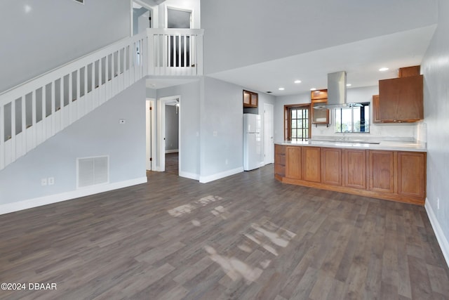 kitchen featuring island range hood, sink, dark hardwood / wood-style floors, white fridge, and kitchen peninsula