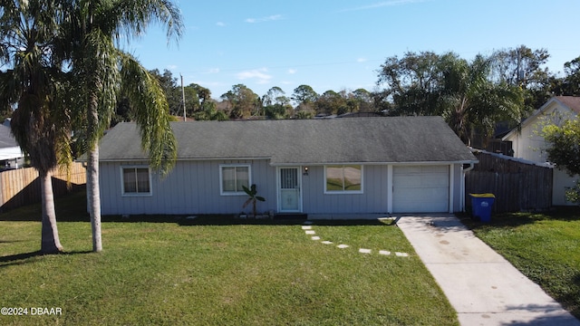 ranch-style home with a garage and a front lawn