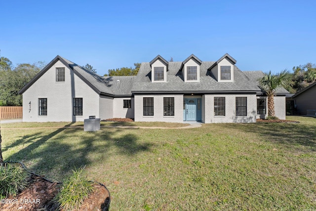 cape cod house featuring a front yard