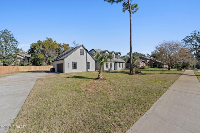 view of front of house with a front yard and a garage