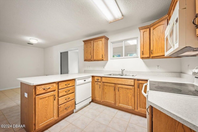 kitchen with white dishwasher, kitchen peninsula, a textured ceiling, stove, and sink