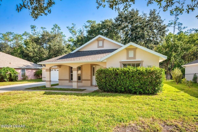 view of front of property with a garage and a front yard