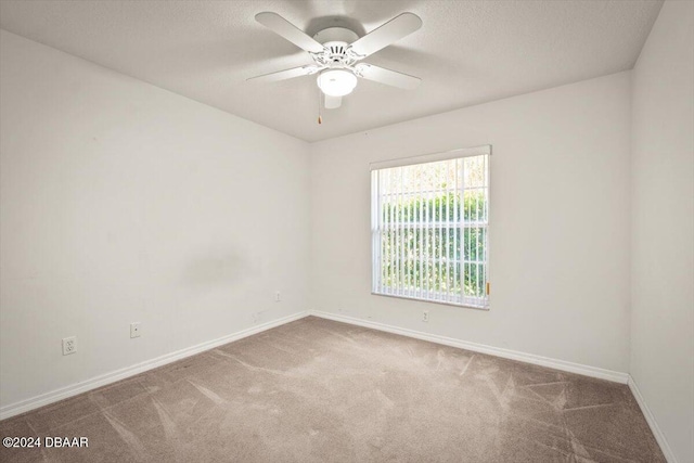 spare room with carpet flooring and ceiling fan