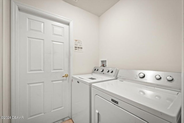 clothes washing area with washer and clothes dryer