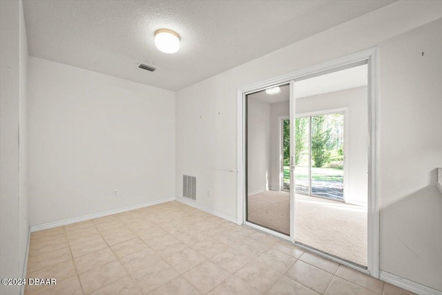 empty room with a textured ceiling