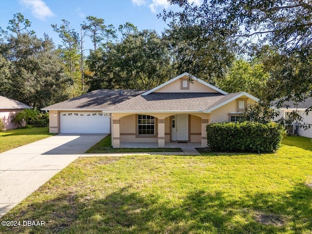 view of front of property featuring a garage and a front lawn