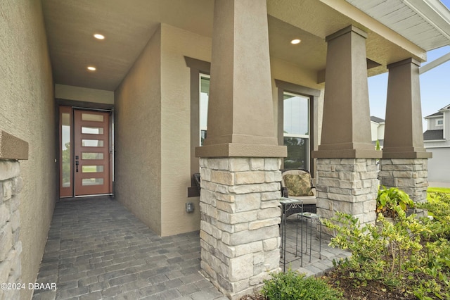 property entrance featuring stucco siding