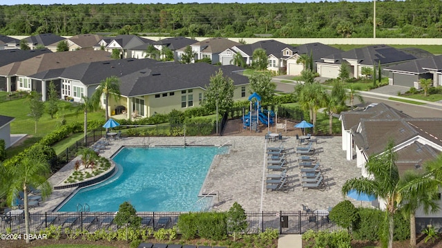 view of swimming pool with a playground