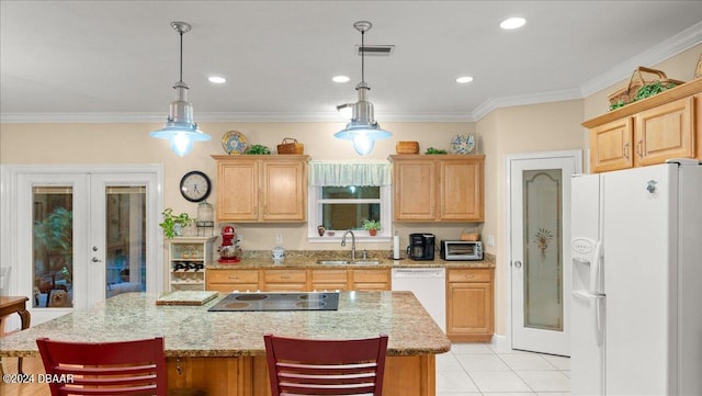 kitchen with a kitchen island, pendant lighting, white appliances, and french doors