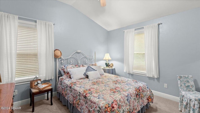 bedroom featuring vaulted ceiling, light carpet, and ceiling fan