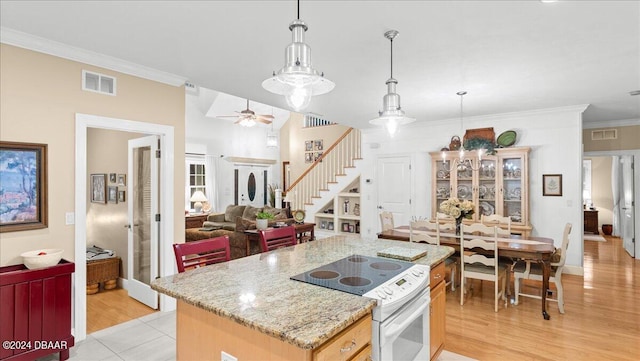 kitchen with light hardwood / wood-style flooring, hanging light fixtures, crown molding, and electric stove