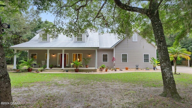 view of front of house with covered porch and a front yard