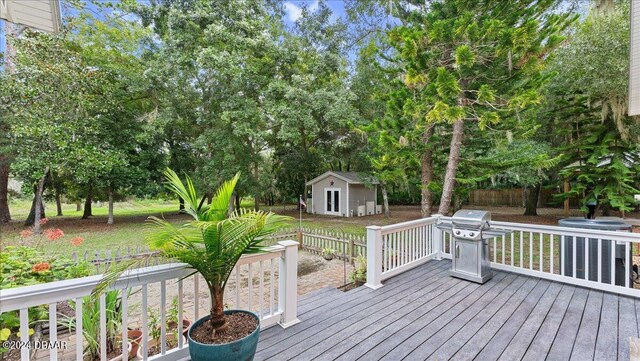 5711 John Anderson Hwy, Flagler Beach, FL 32136 - wooden deck with an outbuilding, area for grilling, fence, and view of scattered trees