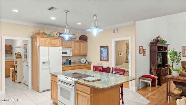 kitchen with ornamental molding, decorative light fixtures, white appliances, light hardwood / wood-style flooring, and a center island