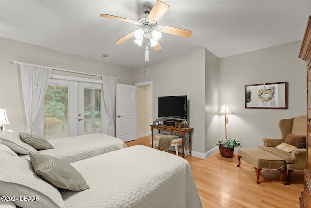 bedroom featuring ceiling fan, access to exterior, light hardwood / wood-style flooring, and french doors