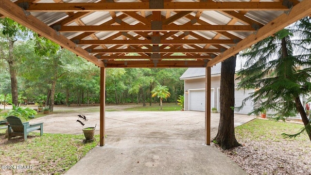 view of patio / terrace with a garage and a gazebo