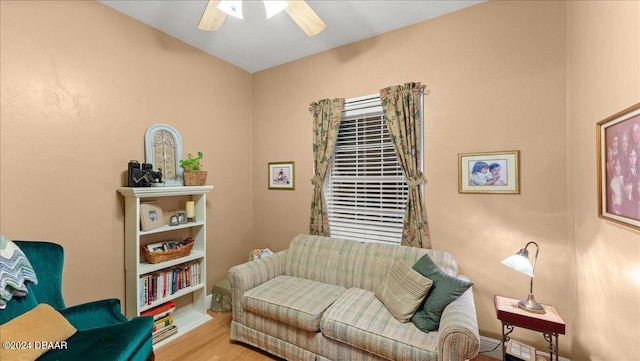 living room with hardwood / wood-style flooring and ceiling fan