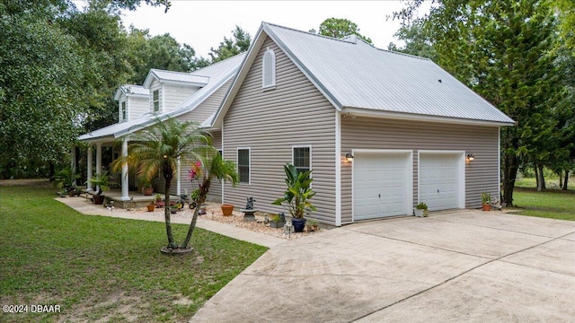 view of side of home featuring a garage and a lawn