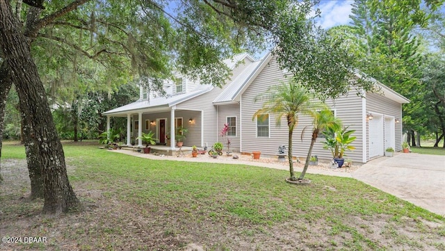 view of front of house featuring a garage, a front yard, and a porch