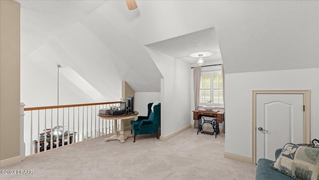 sitting room featuring lofted ceiling, light colored carpet, and ceiling fan