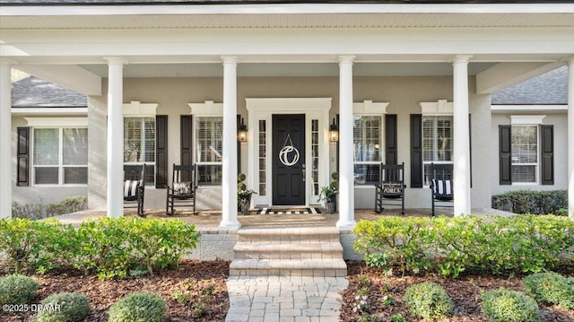 doorway to property featuring covered porch