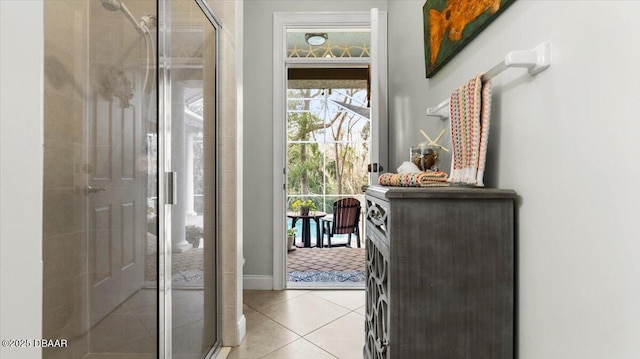 bathroom with walk in shower and tile patterned flooring