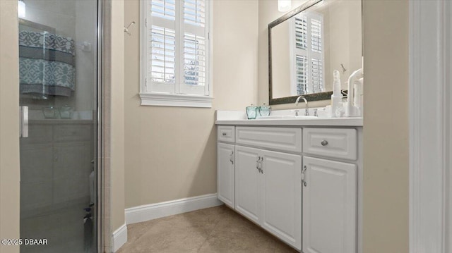 bathroom with walk in shower, vanity, and tile patterned flooring