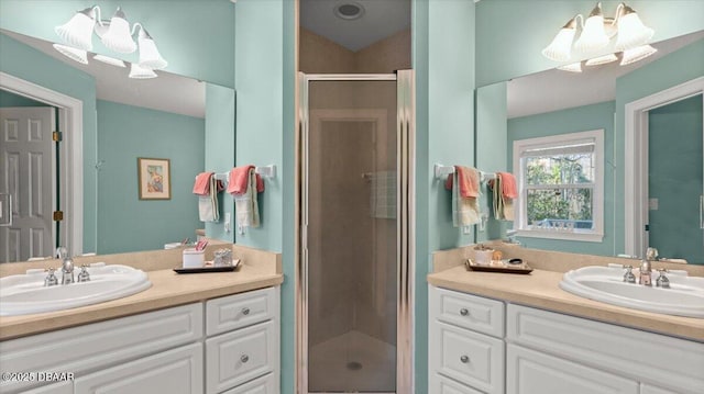 bathroom featuring vanity and a shower with shower door