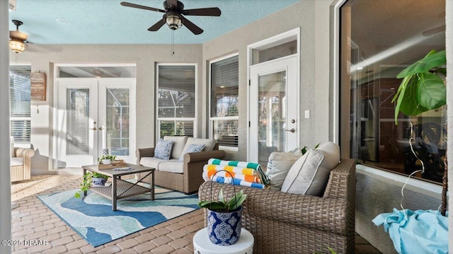 sunroom with ceiling fan and french doors