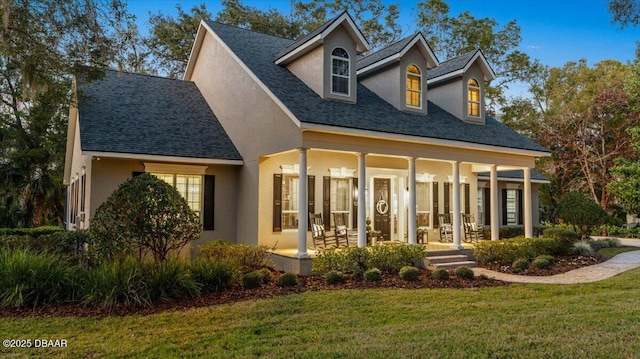 view of front facade featuring covered porch and a front lawn