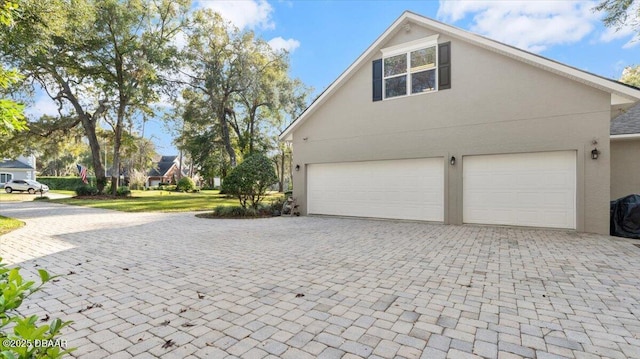 view of property exterior featuring a garage and a yard