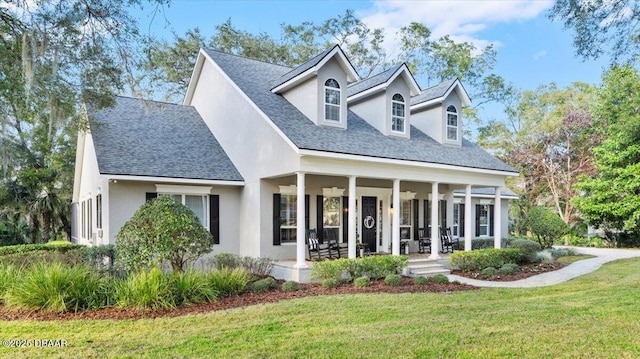 view of front of home with a porch and a front lawn