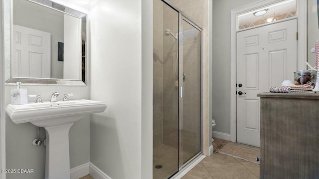 bathroom with tile patterned flooring, toilet, and walk in shower