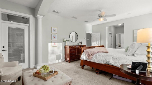 carpeted bedroom with ceiling fan and decorative columns