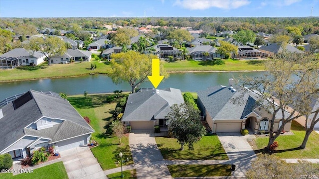 drone / aerial view featuring a residential view and a water view