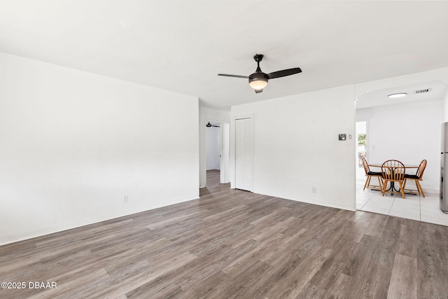 unfurnished room featuring ceiling fan and light wood-type flooring