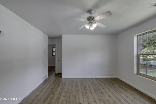 607 Marlene Dr, Holly Hill, FL 32117 - spare room featuring wood finished floors and a ceiling fan