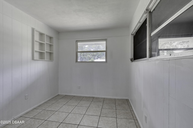 607 Marlene Dr, Holly Hill, FL 32117 - unfurnished room featuring built in features, light tile patterned floors, and wood walls