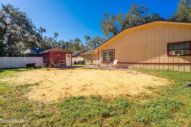894 Quarters Ct, Port Orange, FL 32129 - fenced backyard featuring a storage unit, cooling unit, and a patio