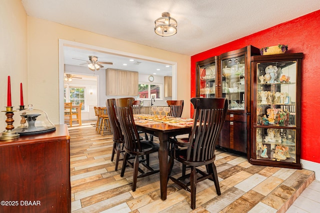 894 Quarters Ct, Port Orange, FL 32129 - dining space with a ceiling fan, light wood-style floors, and a textured ceiling