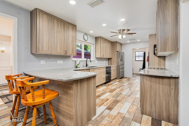894 Quarters Ct, Port Orange, FL 32129 - kitchen featuring stainless steel refrigerator with ice dispenser, a peninsula, a breakfast bar, a ceiling fan, and plenty of natural light