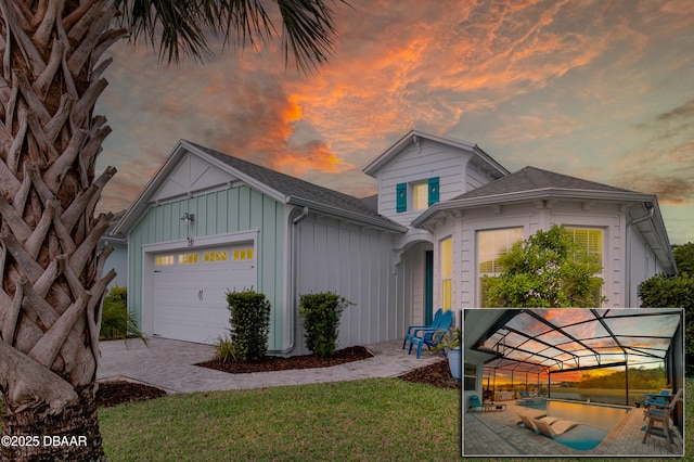 281 Compass Rose Dr, Daytona Beach, FL 32124 - view of front facade with board and batten siding, an attached garage, decorative driveway, a shingled roof, and a front yard