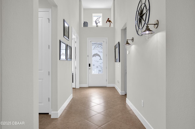 281 Compass Rose Dr, Daytona Beach, FL 32124 - entryway with tile patterned flooring, baseboards, and a towering ceiling