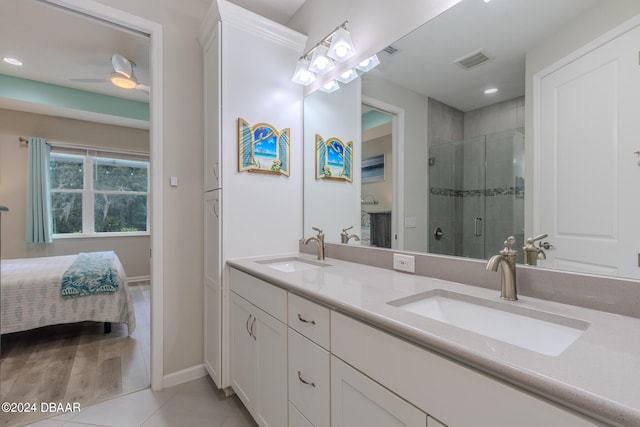 bathroom with walk in shower, vanity, tile patterned floors, and ceiling fan