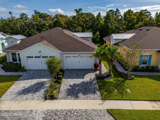 ranch-style home with a garage and a front yard