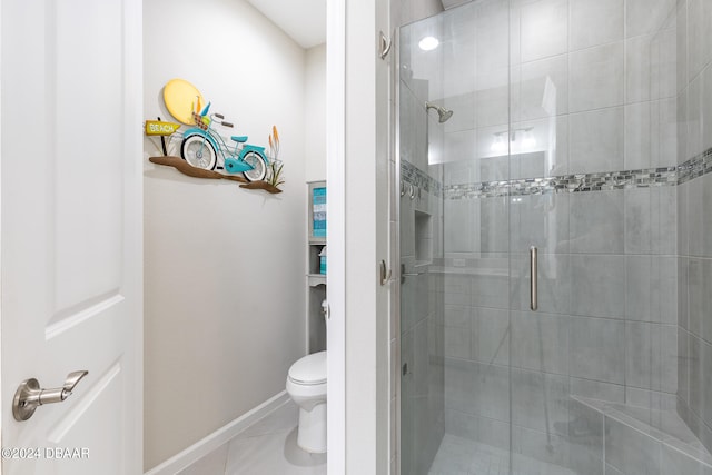 bathroom featuring toilet and a shower with door