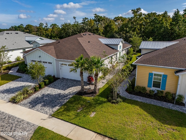 exterior space featuring a garage and a front lawn