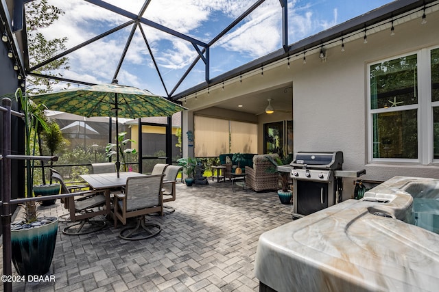 view of patio with grilling area, a lanai, and ceiling fan